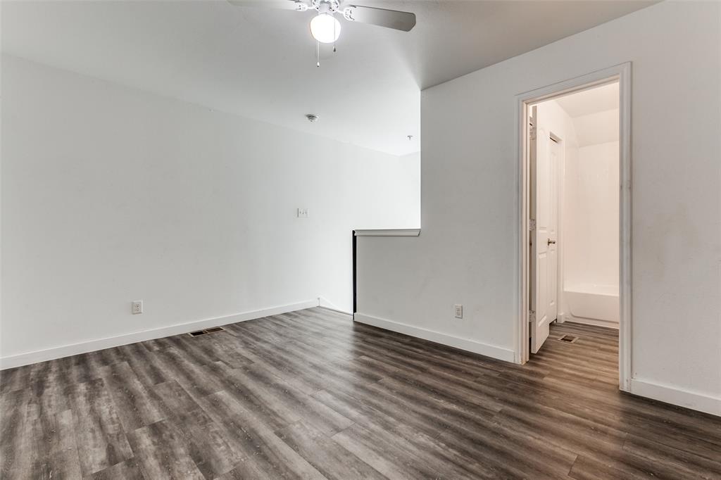 9829 Walnut Street, Unit 210 Dallas, TX 75243 - Photo 15 of 19 an empty room with wooden floor and windows