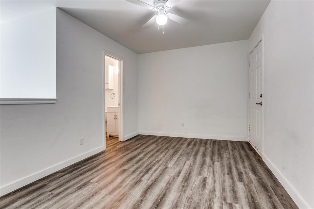 9829 Walnut Street, Unit 210 Dallas, TX 75243 - Photo 16 of 19 an empty room with wooden floor and windows