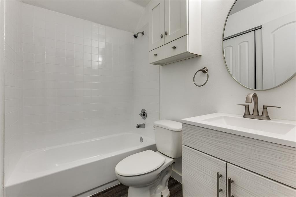 9829 Walnut Street, Unit 210 Dallas, TX 75243 - Photo 18 of 19 a bathroom with a sink a toilet and a bathtub