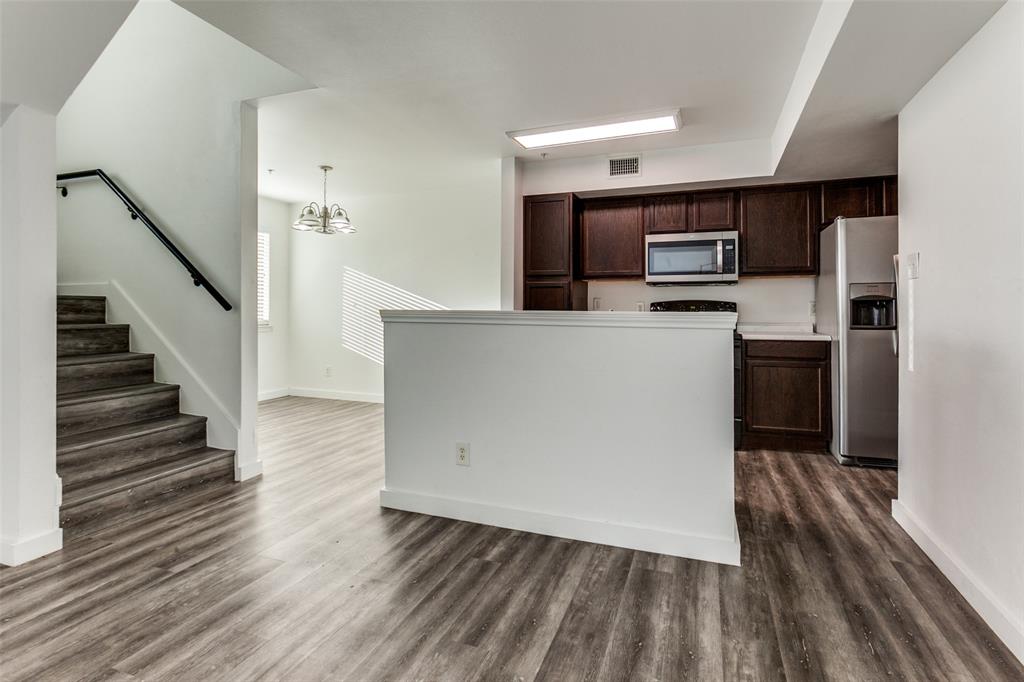 9829 Walnut Street, Unit 210 Dallas, TX 75243 - Photo 6 of 19 a view of kitchen with stainless steel appliances a refrigerator and a stove top oven