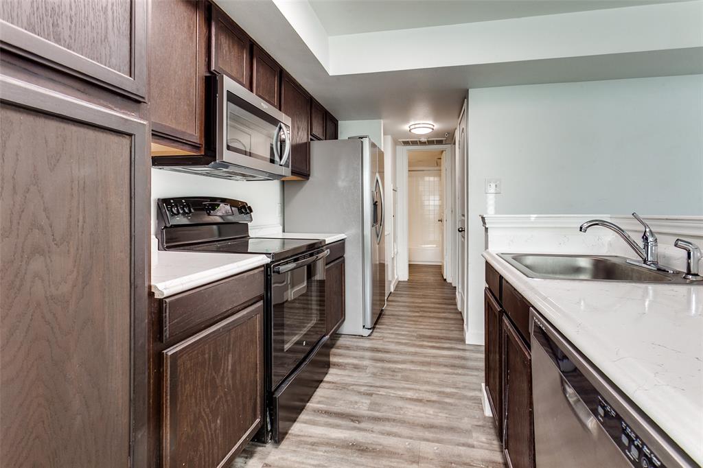 9829 Walnut Street, Unit 210 Dallas, TX 75243 - Photo 7 of 19 a kitchen with a sink stove and refrigerator