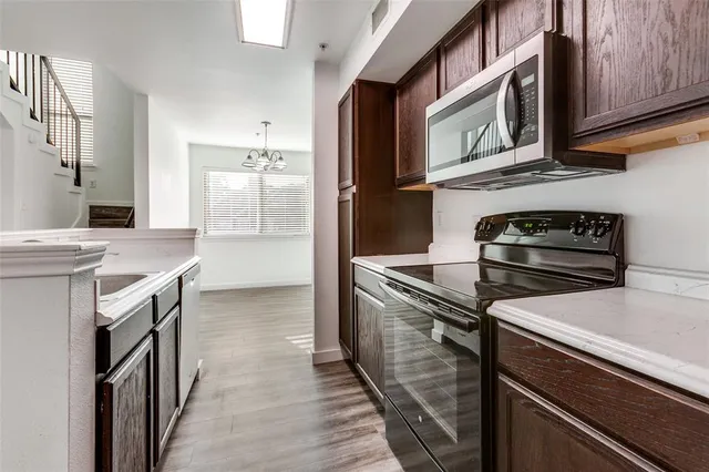 a kitchen with stainless steel appliances granite countertop a stove and a refrigerator