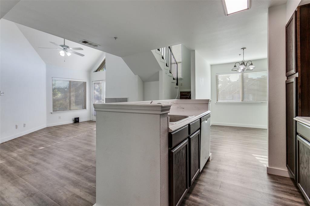 9829 Walnut Street, Unit 210 Dallas, TX 75243 - Photo 9 of 19 a kitchen with granite countertop a sink and a stove top oven