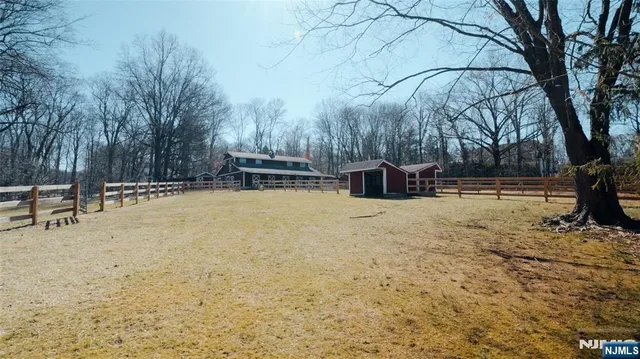 a view of a white house with a snow on the road