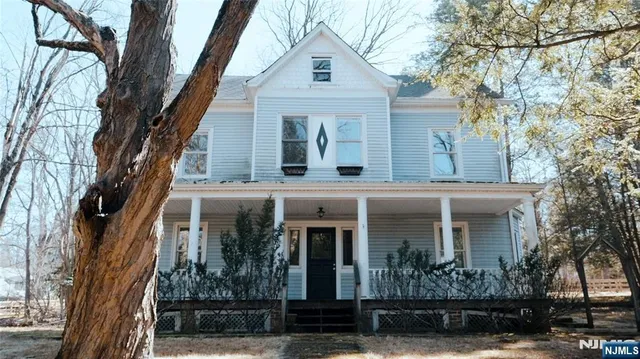 a view of a house with snow on the road