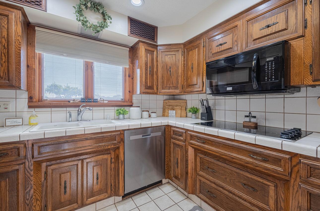 1527 Atherton Way Salinas, CA 93906 - Photo 11 of 64 a kitchen with stainless steel appliances granite countertop a sink stove and microwave