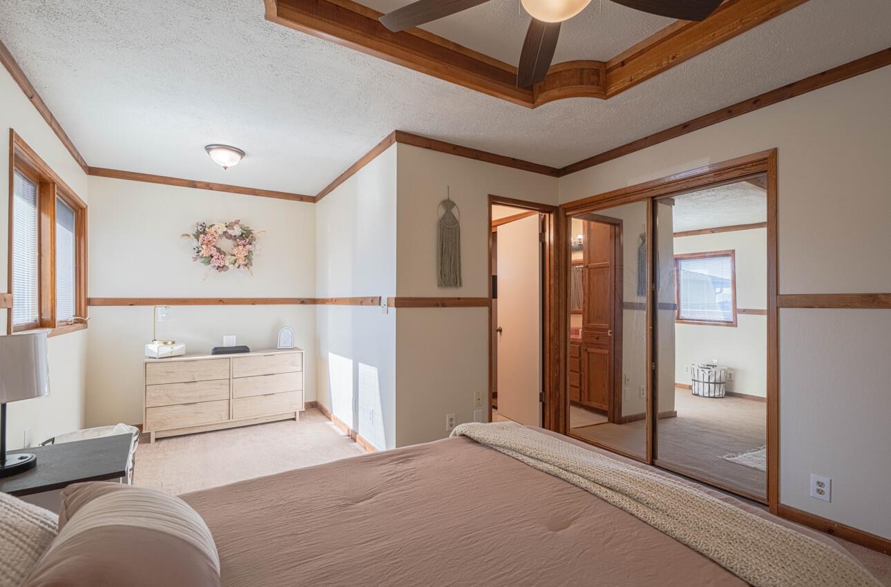 1527 Atherton Way Salinas, CA 93906 - Photo 38 of 64 a bedroom with a large bed and a chandelier