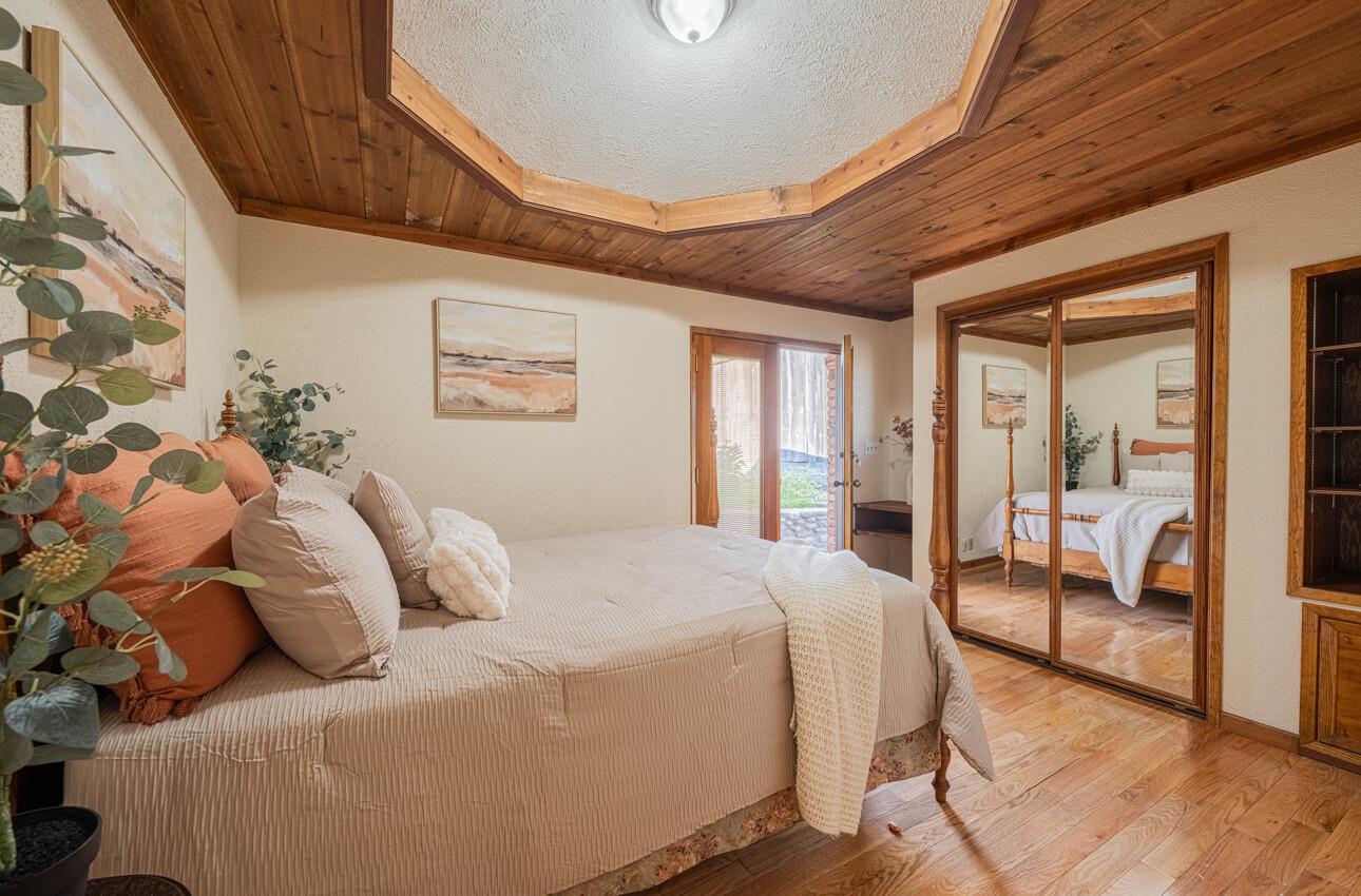 1527 Atherton Way Salinas, CA 93906 - Photo 47 of 64 a bedroom with a large bed and a chandelier