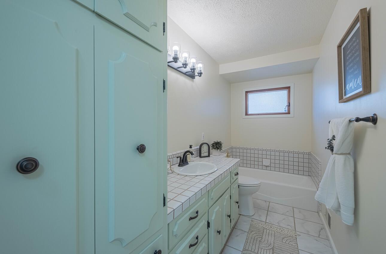 1527 Atherton Way Salinas, CA 93906 - Photo 51 of 64 a bathroom with a sink a toilet and shower