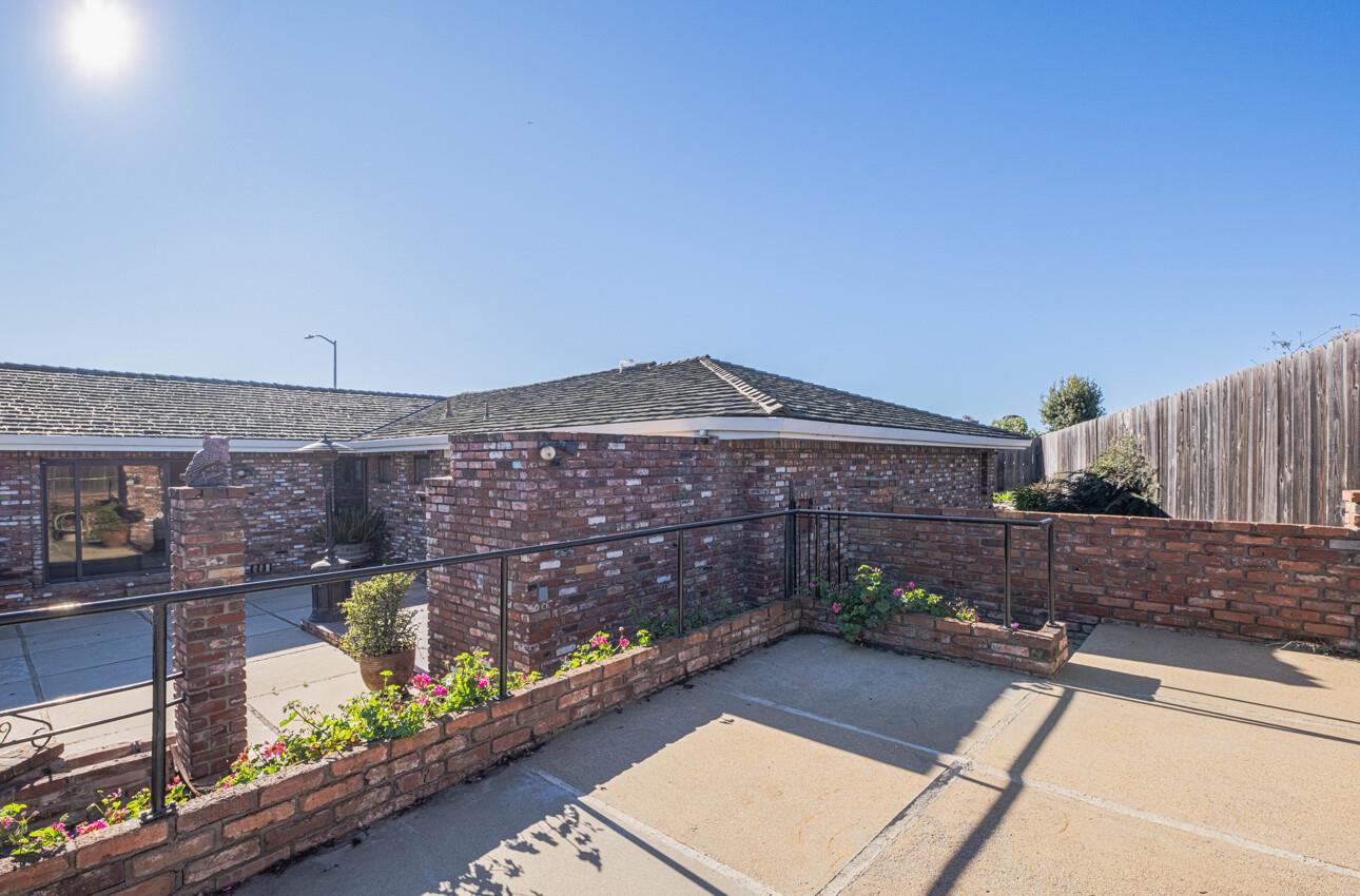 1527 Atherton Way Salinas, CA 93906 - Photo 54 of 64 a view of a brick wall with a bench in patio