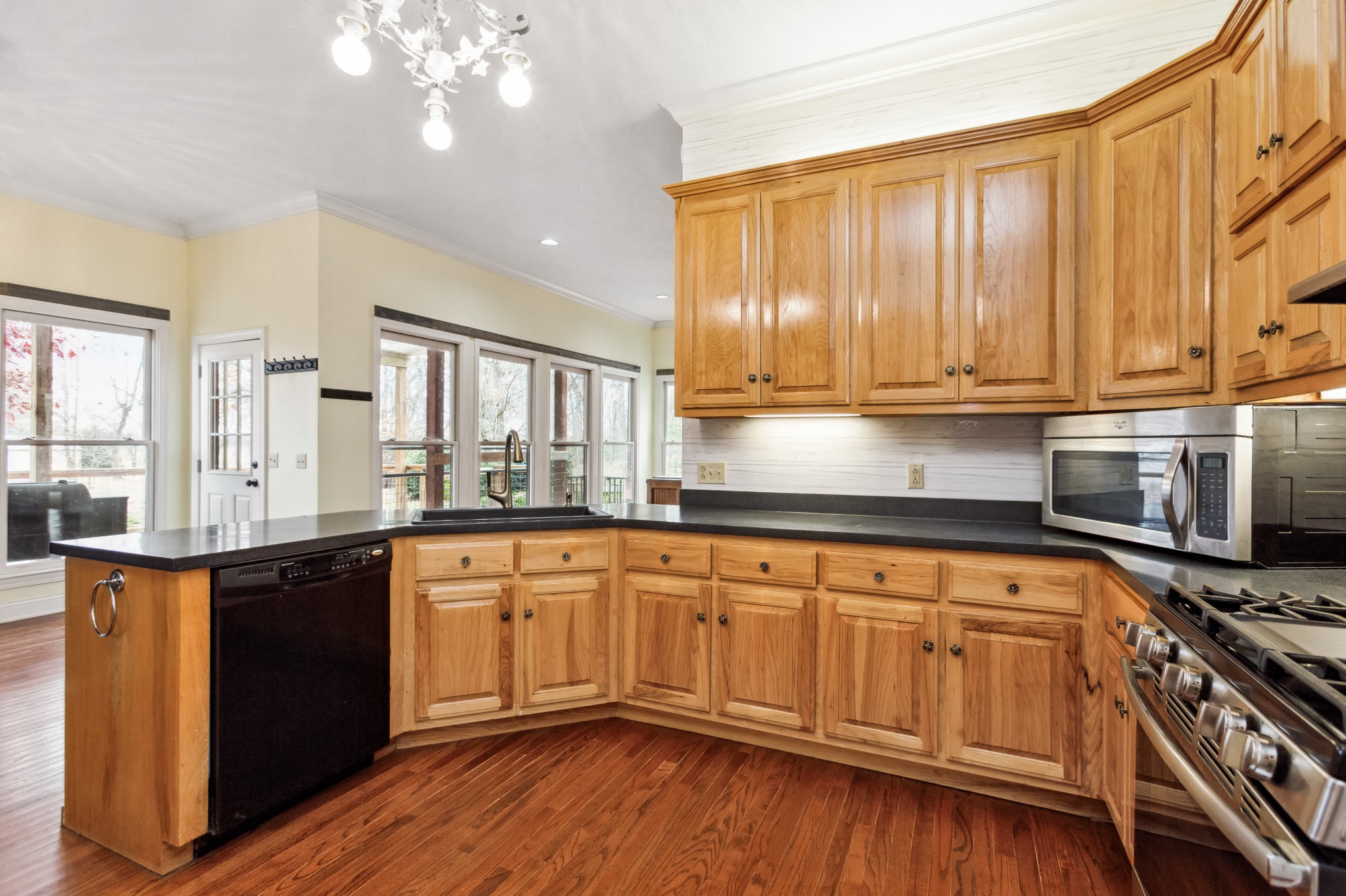 6194 South Lamont Road Springfield, TN 37172 - Photo 33 of 62 a kitchen with stainless steel appliances granite countertop a stove a sink dishwasher and a microwave oven with wooden floor