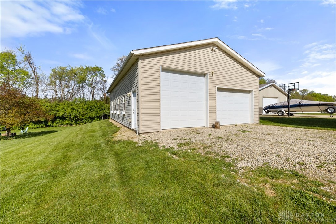 841 Willow Road Springfield, OH 45502 - Photo 48 of 64 This spacious detached garage offers ample storage for vehicles and equipment, complemented by a verdant lawn.