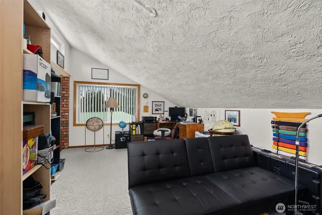 a view of a house with a yard and sitting area