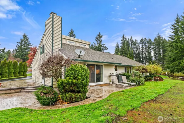 a living room with furniture flat screen tv and a large window