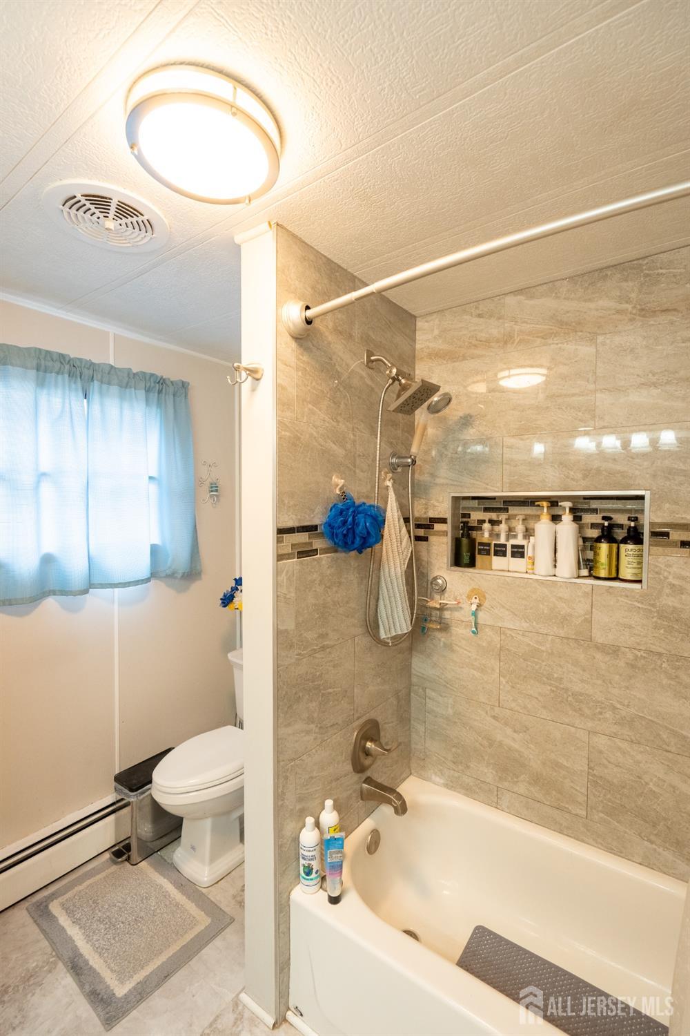 15 Dickens Road North Brunswick, NJ 08902 - Photo 33 of 38 a bathroom with a bathtub and a toilet