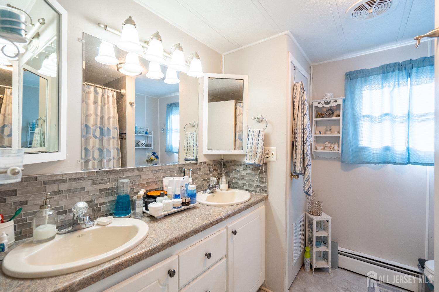15 Dickens Road North Brunswick, NJ 08902 - Photo 34 of 38 a bathroom with a sink and a mirror