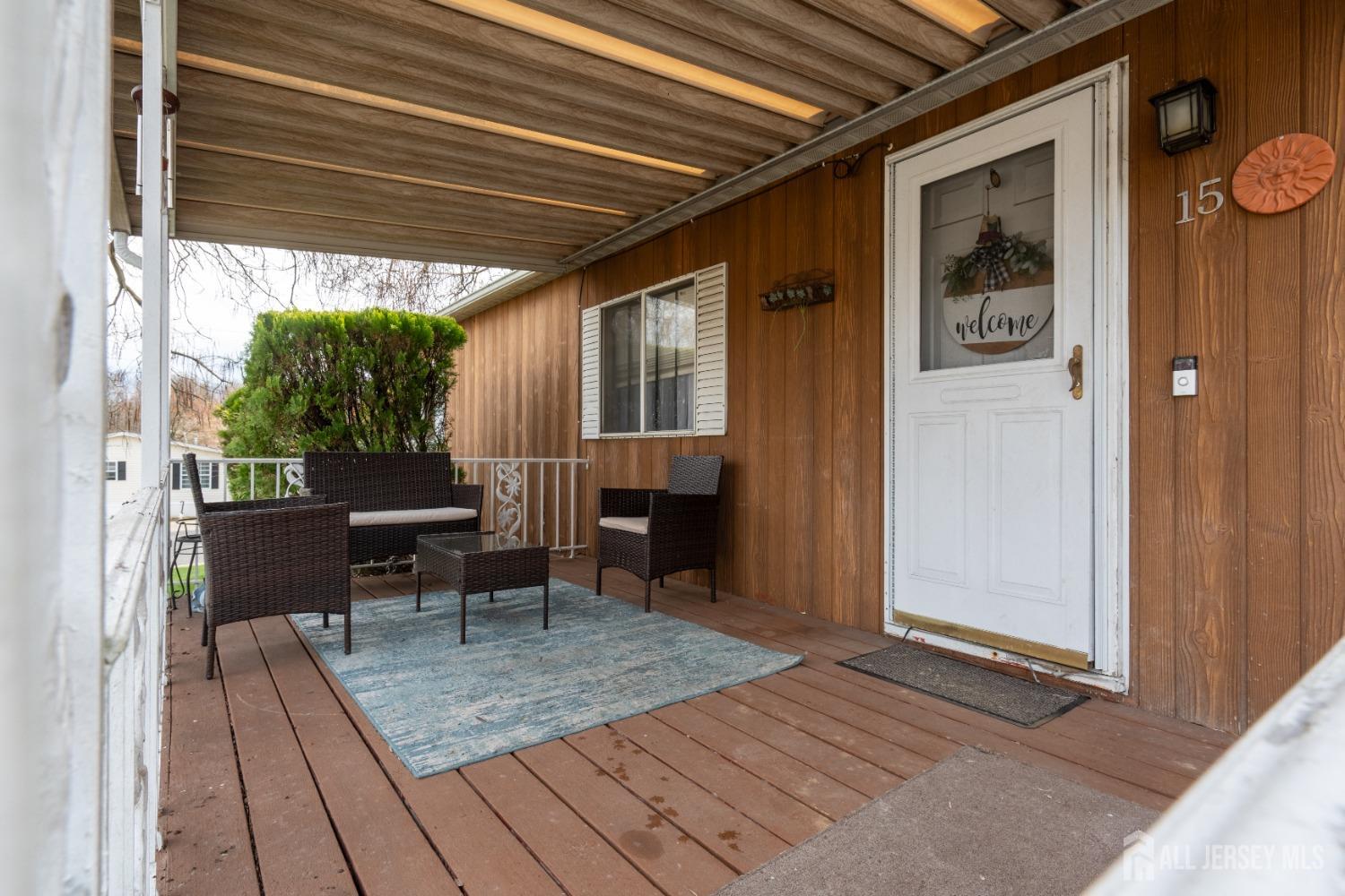 15 Dickens Road North Brunswick, NJ 08902 - Photo 7 of 38 a view of a porch with furniture and a yard