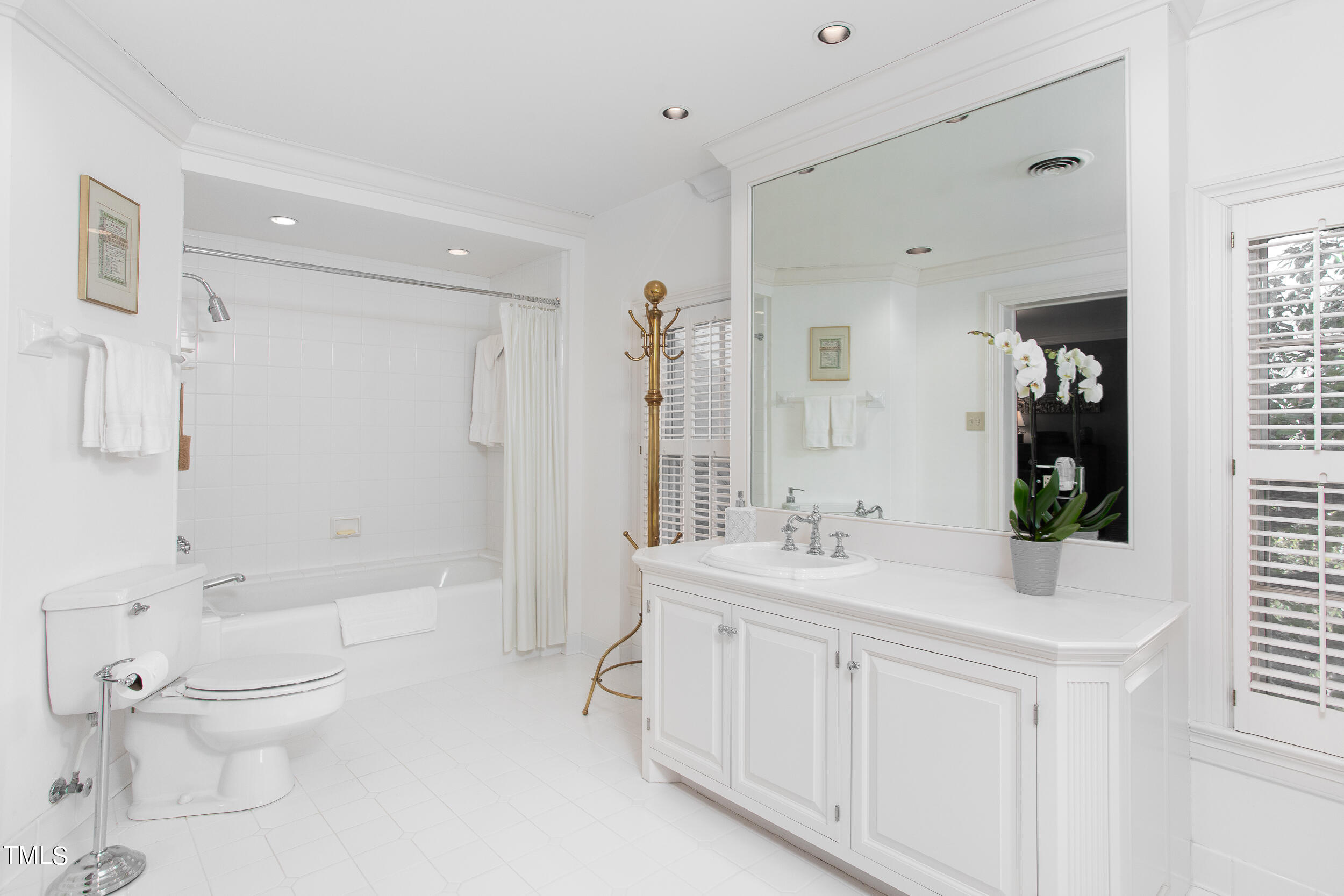 3940 Dover Road Durham, NC 27707 - Photo 55 of 72 a bathroom with a sink a toilet and shower