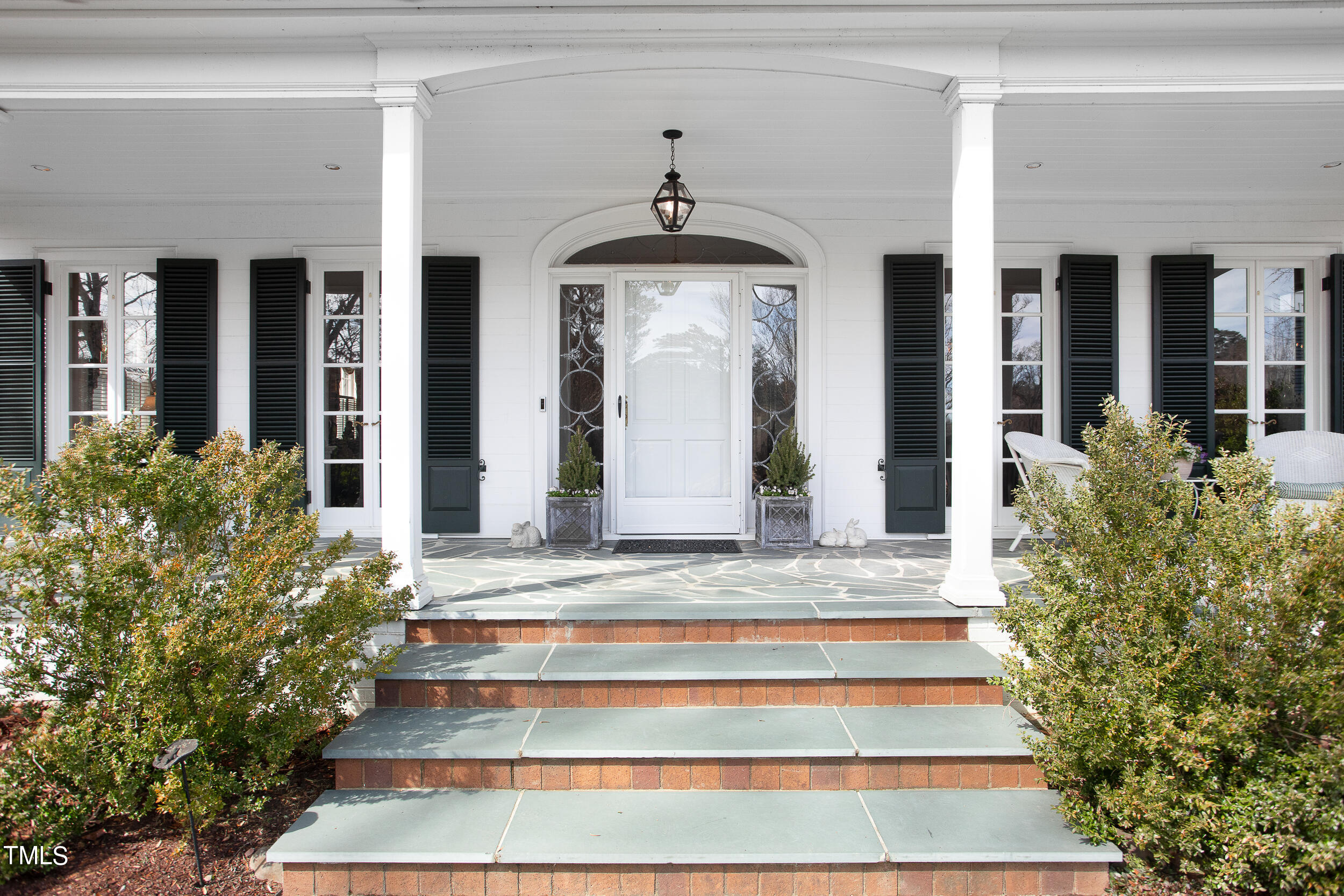 3940 Dover Road Durham, NC 27707 - Photo 9 of 72 a view of a house with potted plants and a bench in front of it