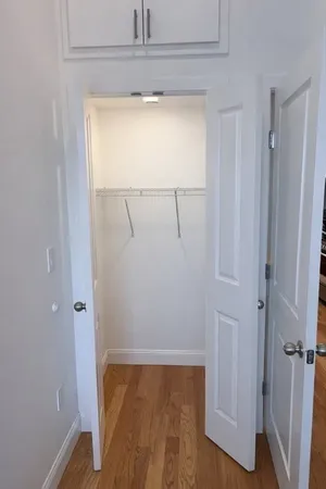a view of small space with wooden floor and closet