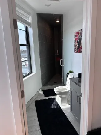 a bathroom with a toilet a sink a vanity and mirror