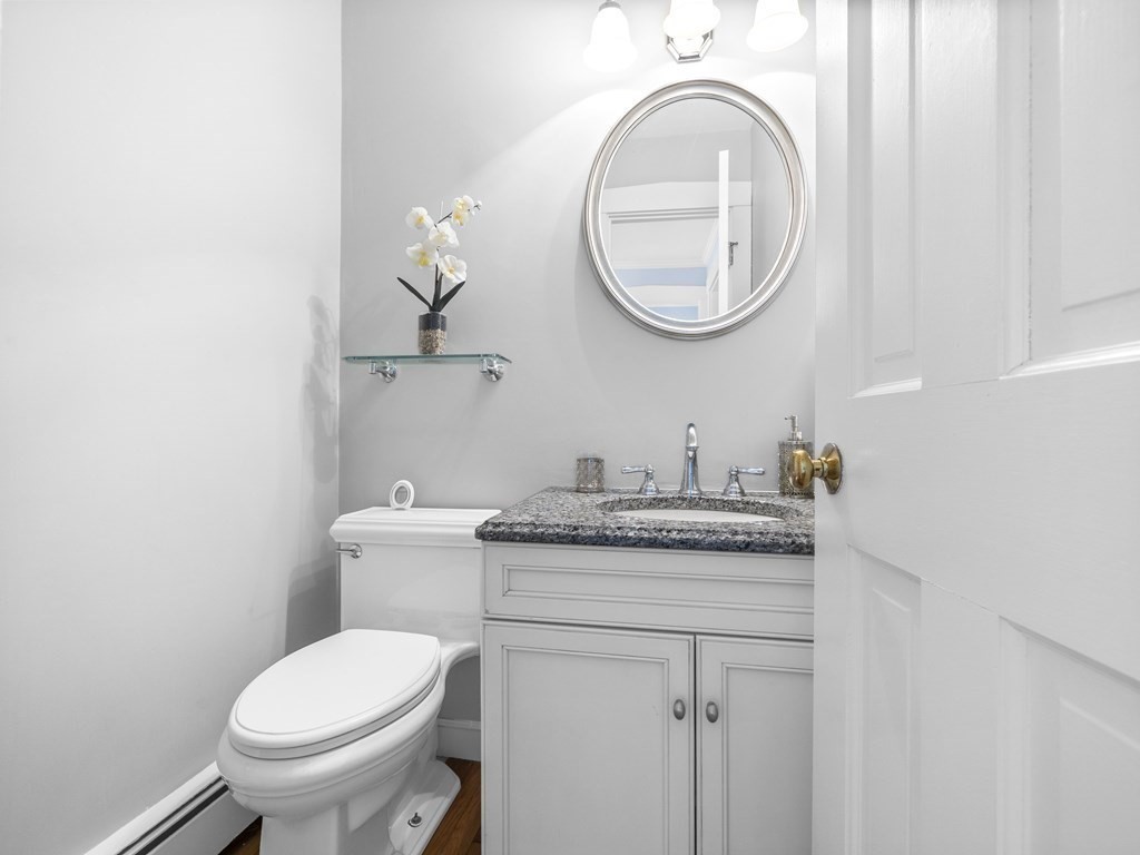 33 Longmeadow Road Wellesley, MA 02482 - Photo 12 of 15 a bathroom with a granite countertop toilet a sink and a mirror