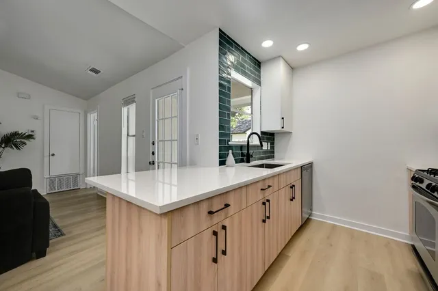 a bathroom with sinks a vanity and a large mirror