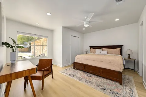 a bedroom with a bed and a table with chair