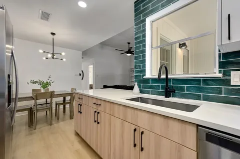 a kitchen with a sink and cabinets