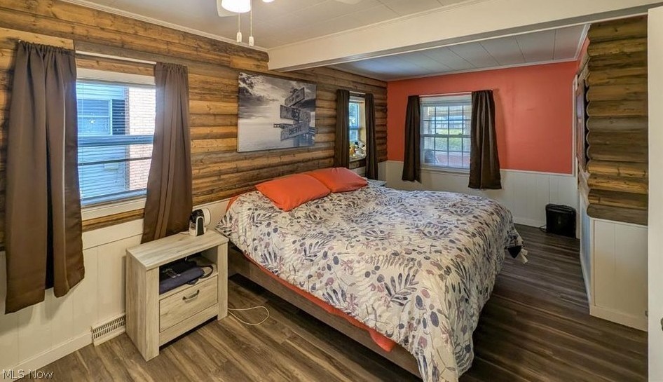41 Poplar Street Huron, OH 44839 - Photo 12 of 37 Bedroom featuring wood-style flooring, rustic walls, multiple windows, a wainscoted wall, and beamed ceiling
