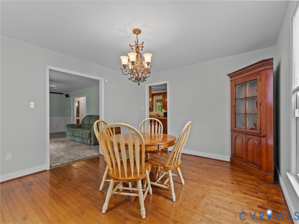 3420 State Rte 656 Powhatan, VA 23139 - Photo 15 of 37 a dining room with furniture a chandelier and wooden floor