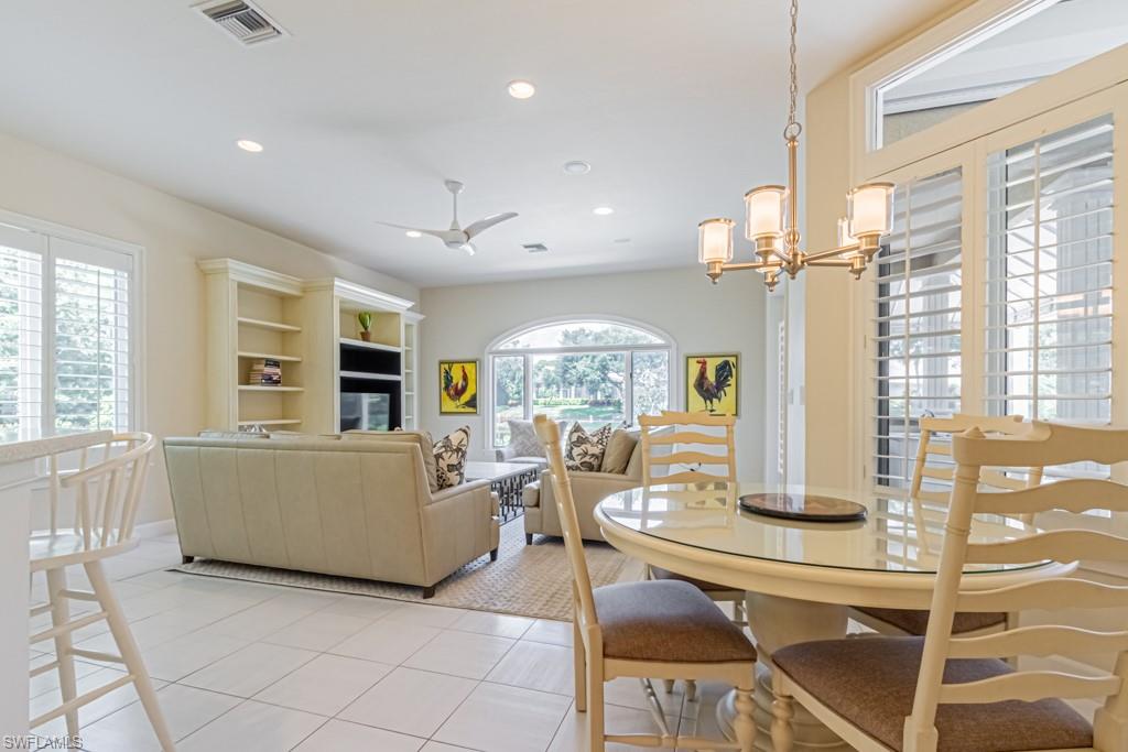 6974 Green Tree Drive Naples, FL 34108 - Photo 12 of 32 a living room with furniture and a table