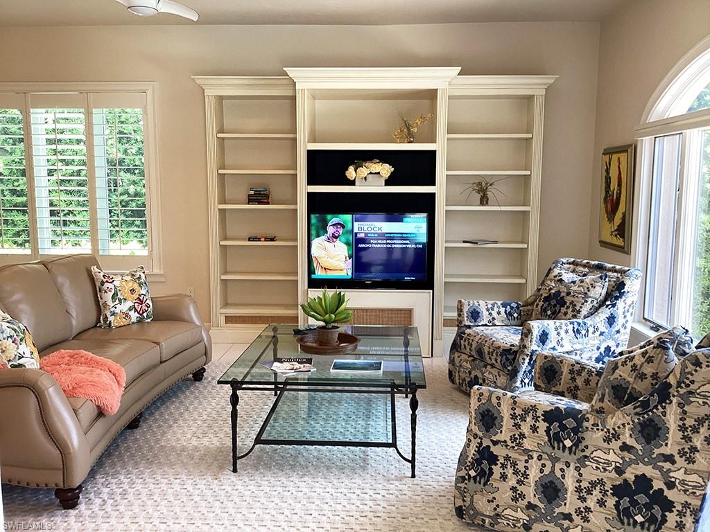 6974 Green Tree Drive Naples, FL 34108 - Photo 13 of 32 a living room with furniture a rug and a window