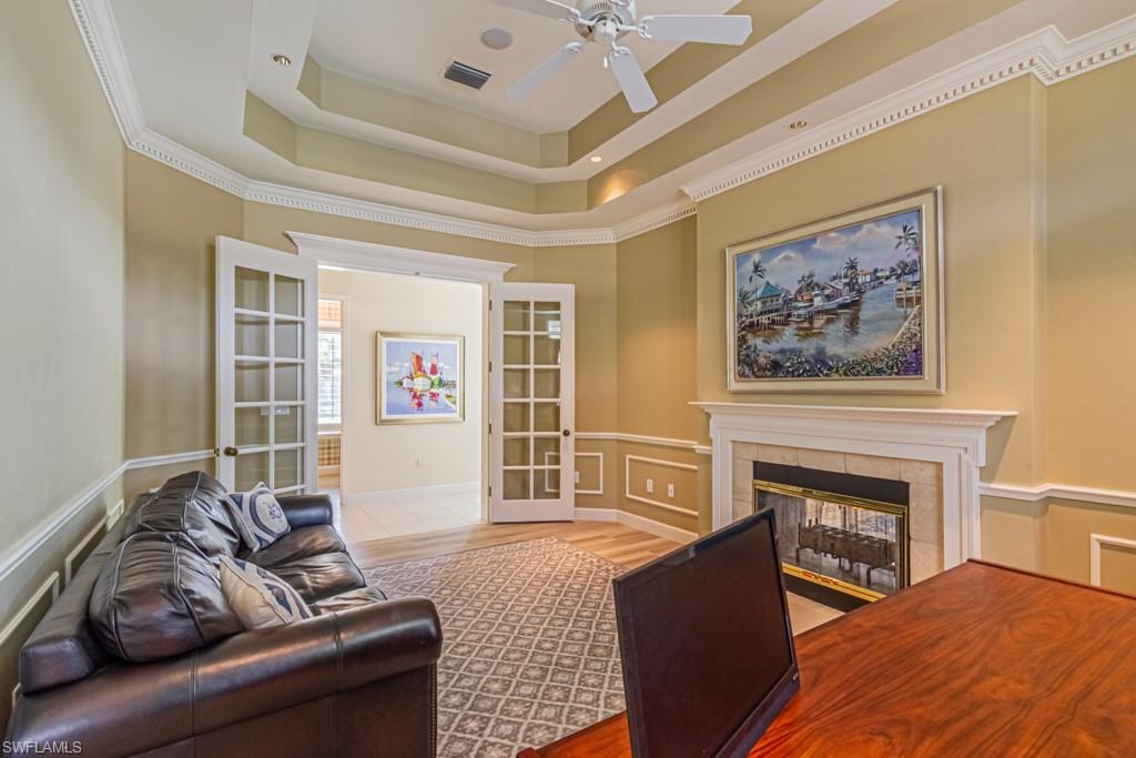 6974 Green Tree Drive Naples, FL 34108 - Photo 20 of 32 a living room with furniture and a fireplace