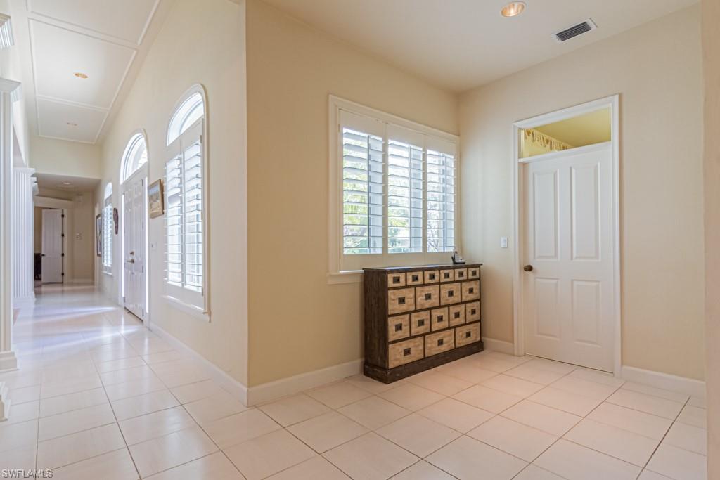 6974 Green Tree Drive Naples, FL 34108 - Photo 23 of 32 an empty room with windows