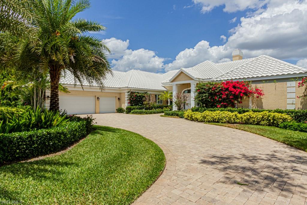 6974 Green Tree Drive Naples, FL 34108 - Photo 4 of 32 a front view of a house with a yard and garage