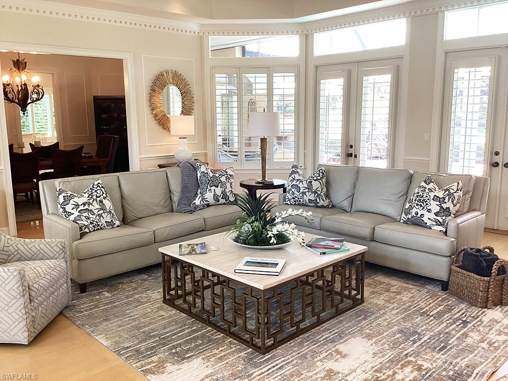 6974 Green Tree Drive Naples, FL 34108 - Photo 6 of 32 a living room with furniture and a large window
