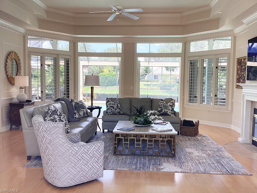 6974 Green Tree Drive Naples, FL 34108 - Photo 7 of 32 a living room with furniture and a large window