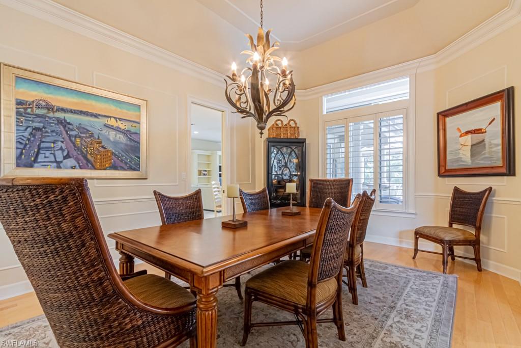 6974 Green Tree Drive Naples, FL 34108 - Photo 9 of 32 a view of a dining room with furniture window and wooden floor