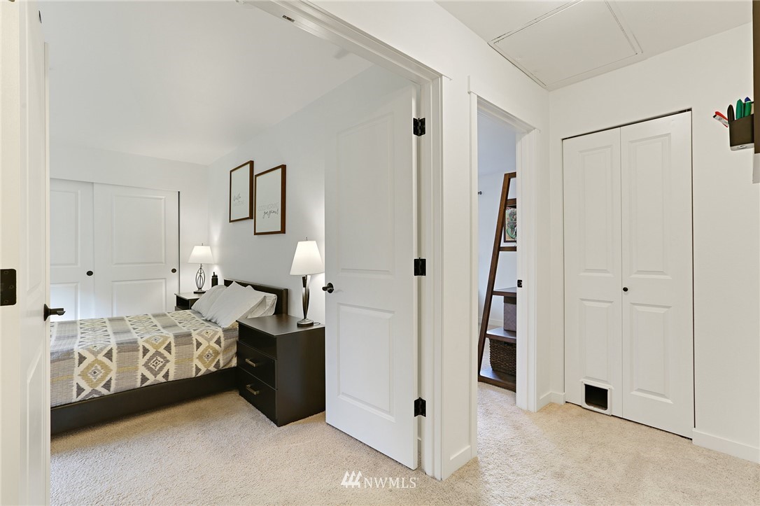 17309 Riverside Place, Unit 3E Bothell, WA 98011 - Photo 14 of 25 a bedroom with a bed and a walk in closet