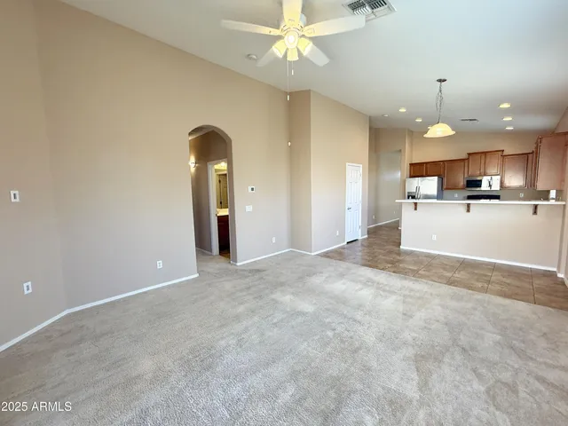a view of a kitchen and a chandelier fan