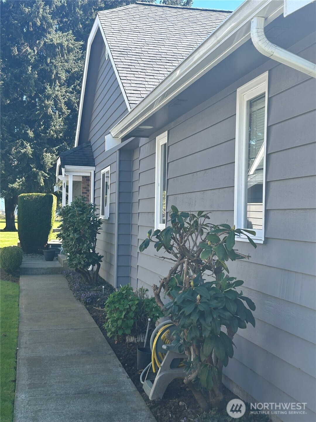 6850 Raspberry Dr., Unit A Everson, WA 98247 - Photo 2 of 22 a front view of a house with garden