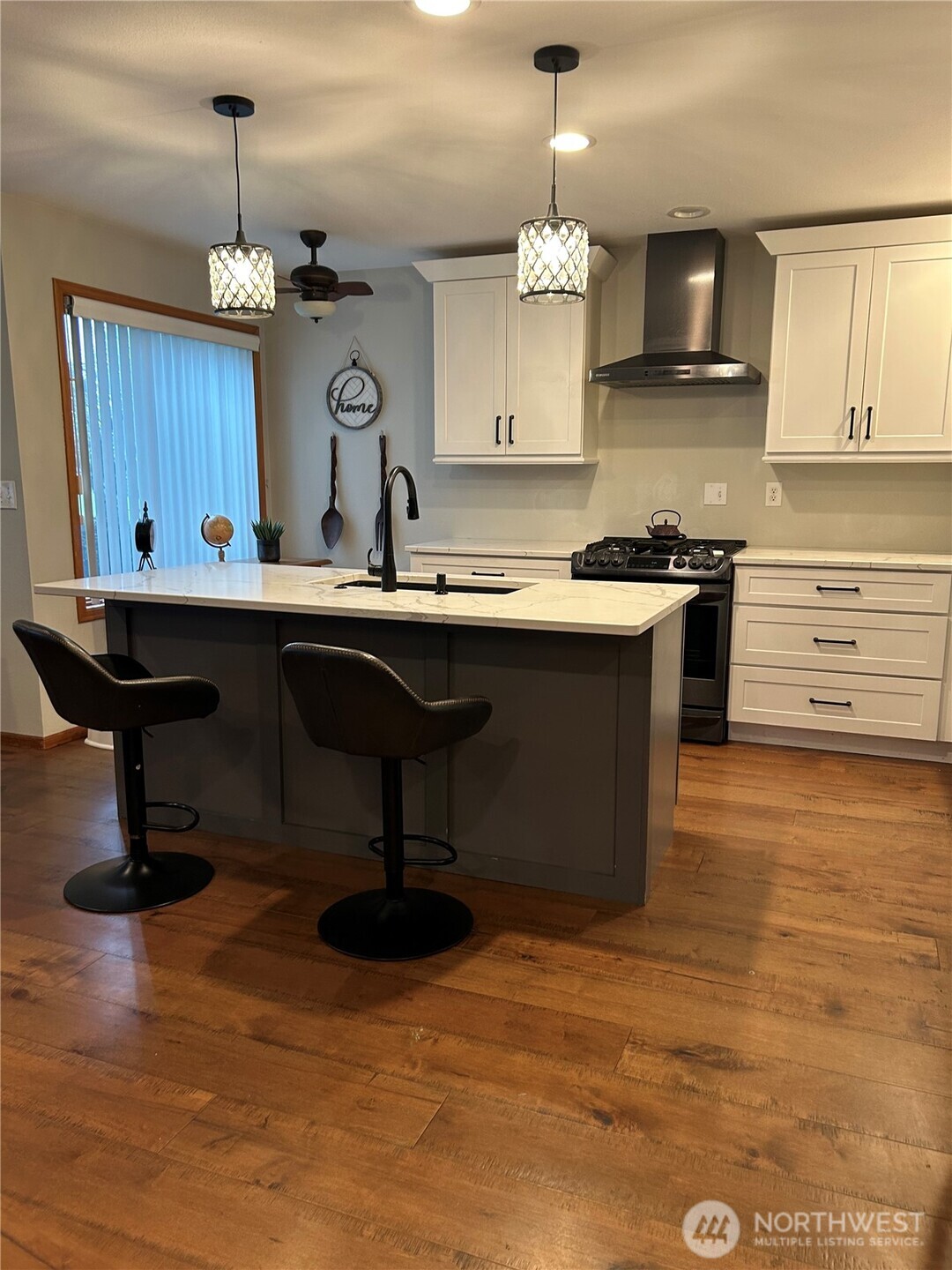 6850 Raspberry Dr., Unit A Everson, WA 98247 - Photo 9 of 22 a kitchen with kitchen island granite countertop a sink cabinets and wooden floor
