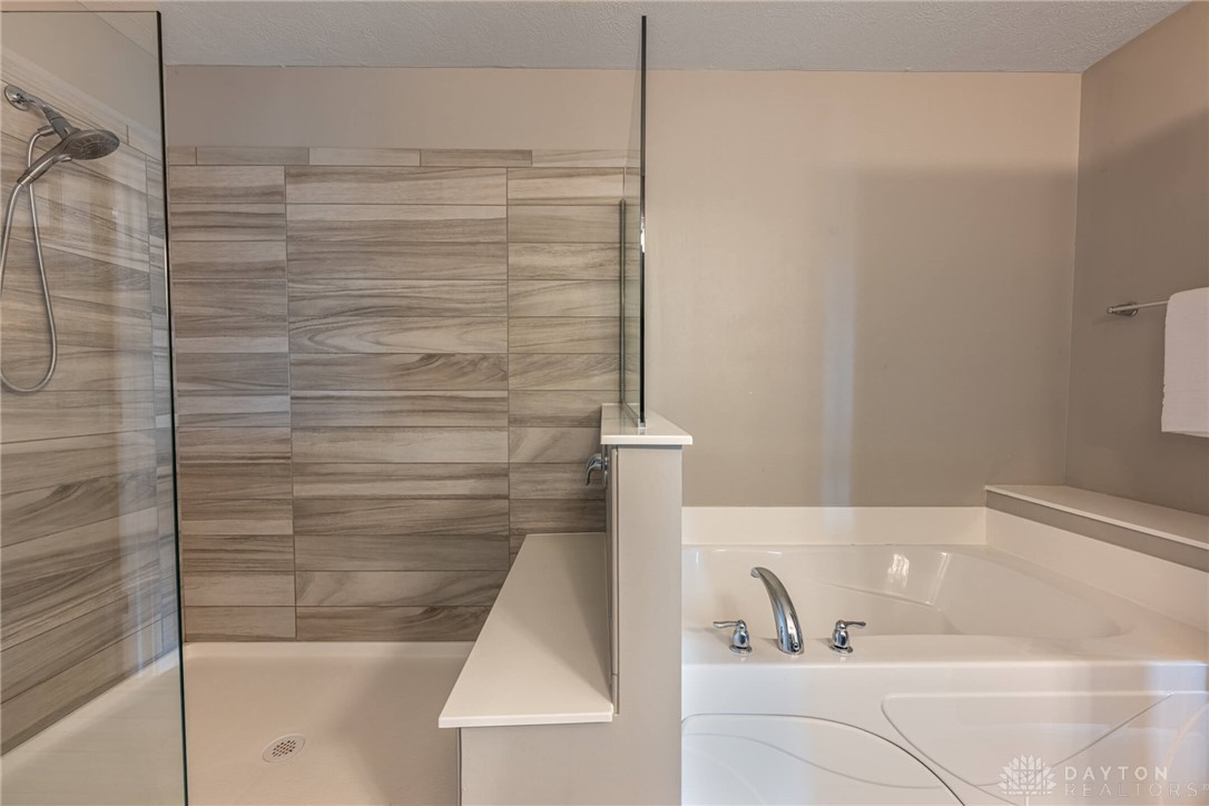 407 Brownstone Row Springboro, OH 45066 - Photo 30 of 54 Relax in the inviting soaking tub or refresh in the spacious shower.