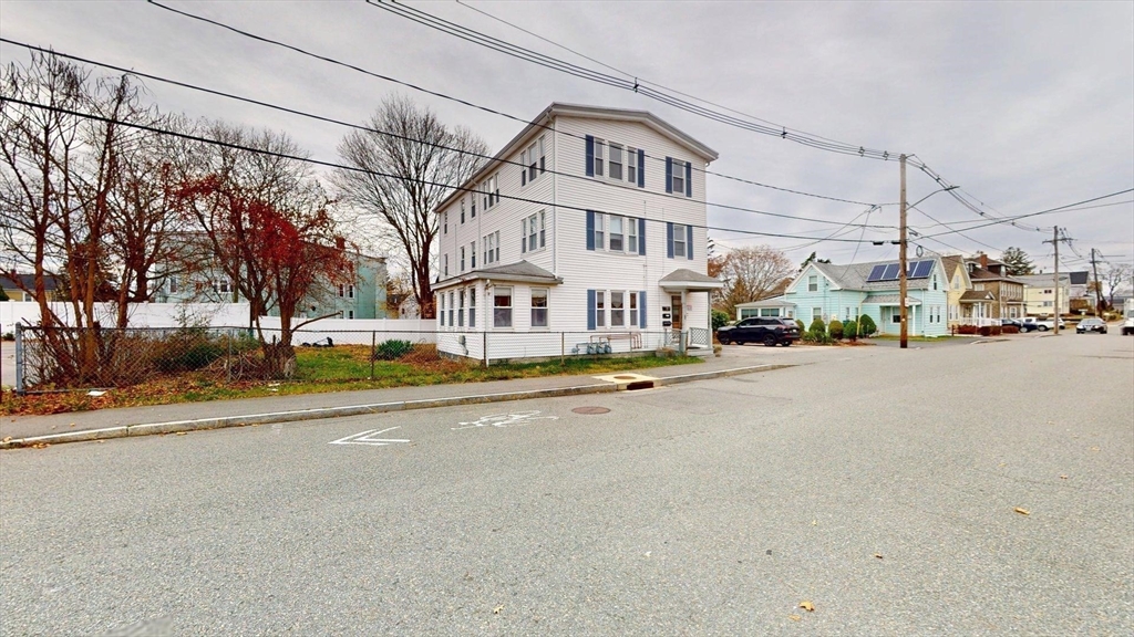 22 Summer Street, Unit 3 Stoughton, MA 02072 - Photo 2 of 4 a view of city street with parked cars