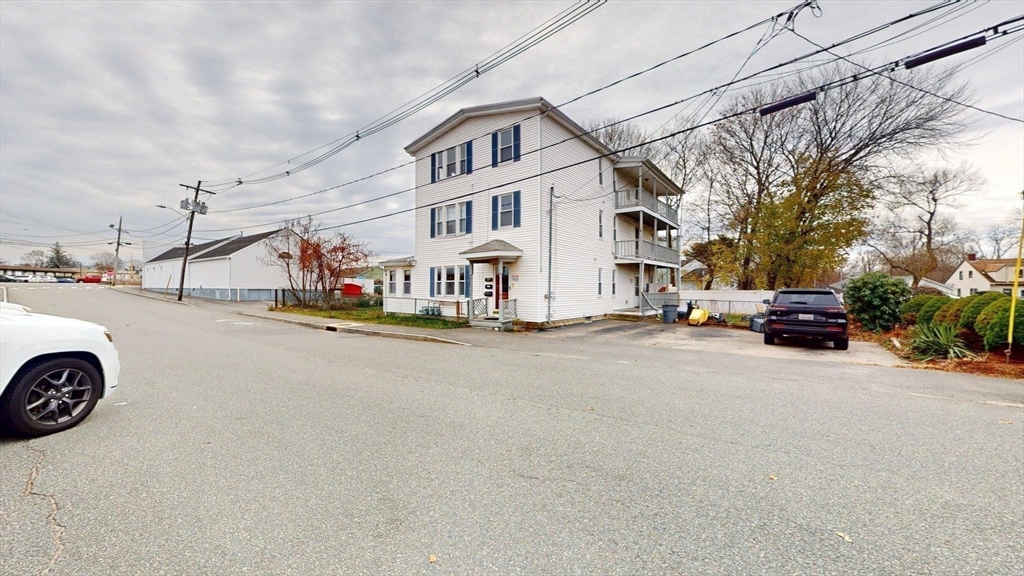 22 Summer Street, Unit 3 Stoughton, MA 02072 - Photo 3 of 4 a view of a street with cars