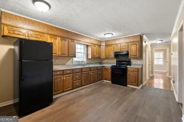 a kitchen with a refrigerator and a sink