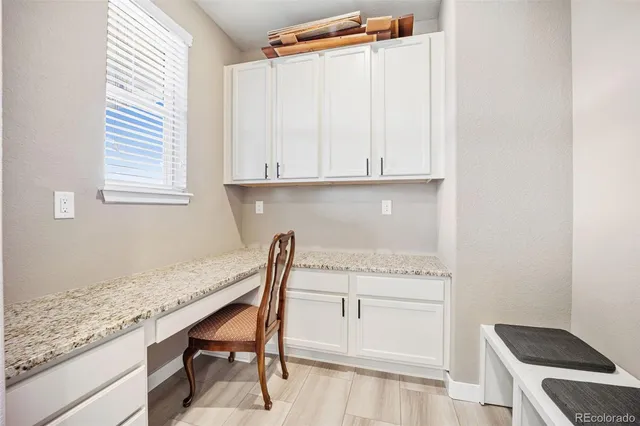 a kitchen with granite countertop white cabinets and white appliances