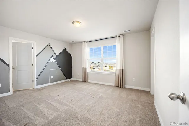 a view of a room that has a window and storage space