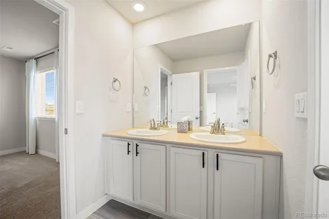 a view of bathroom with dual sinks